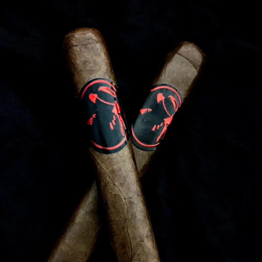 Hand-rolled cigar featuring red brand logo